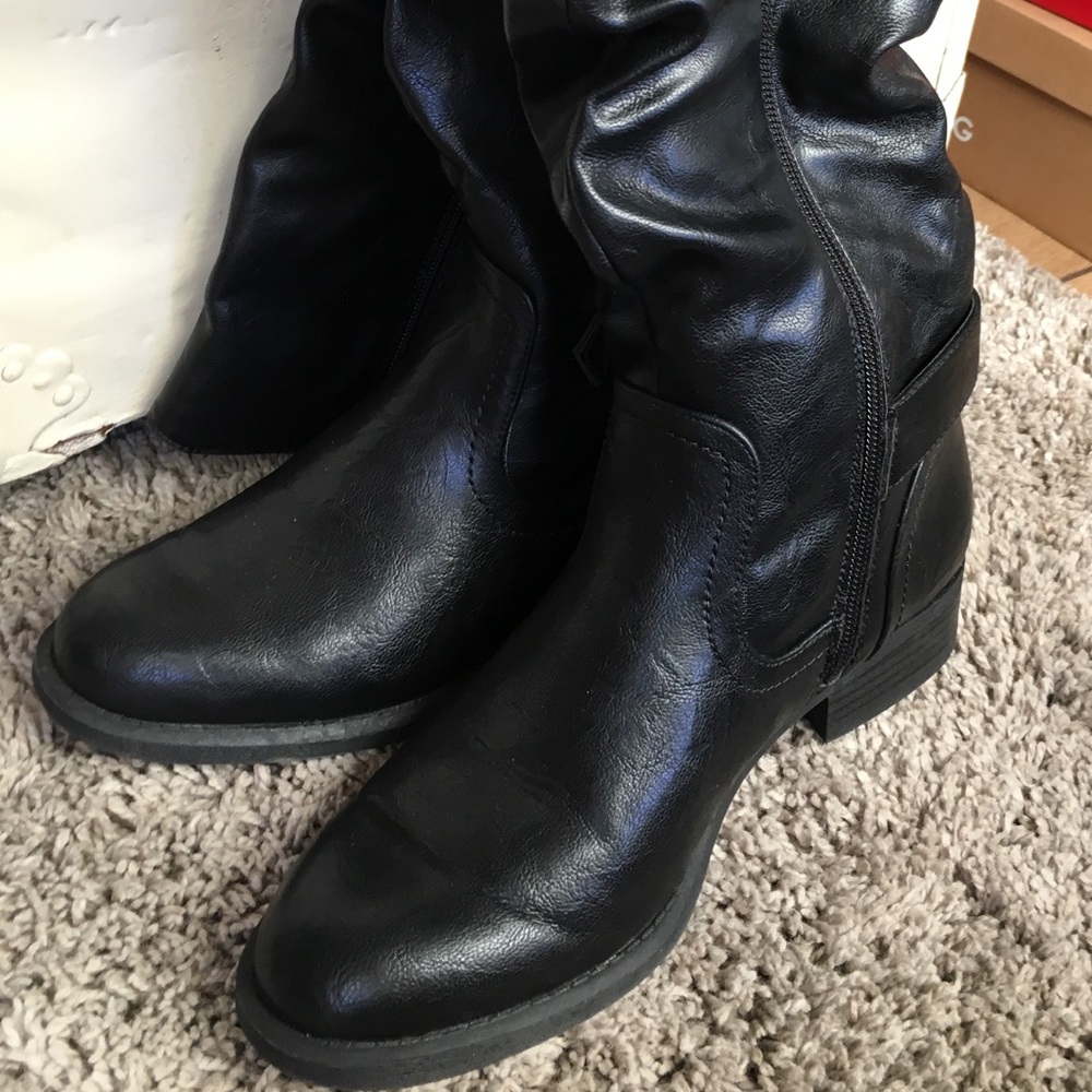 Black boot, hits just below the knee.